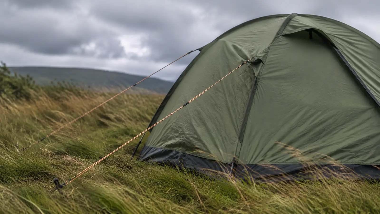 A dome tent with a taut ridgeline and two guylines angled out from the windward side